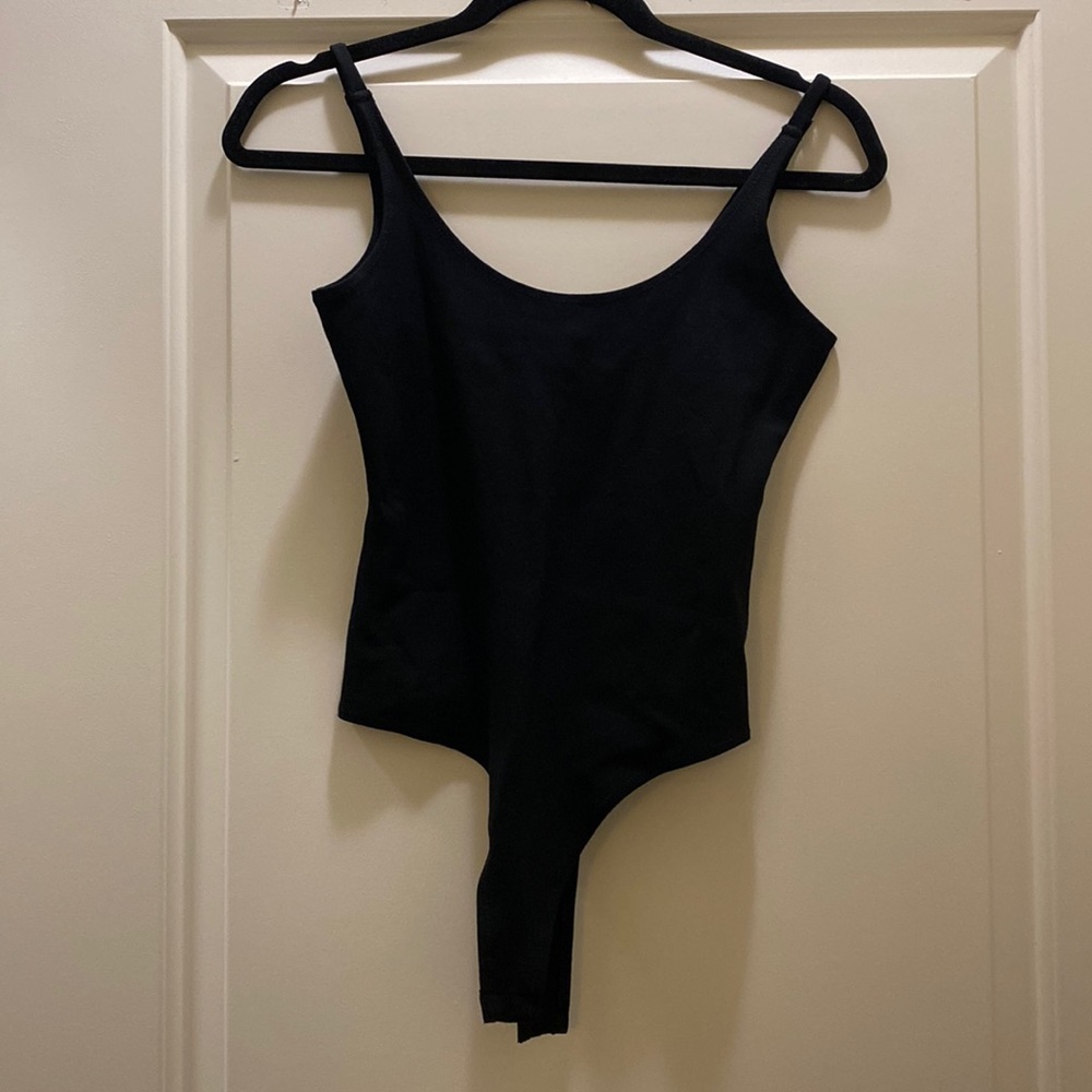This is a thin strap bodysuit. It is a very stretchy material and very fitting.